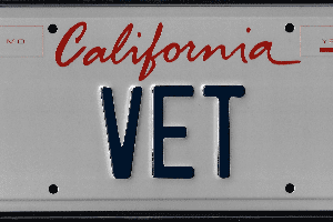 A california vet license plate with the word " california vet " written in red and blue letters.