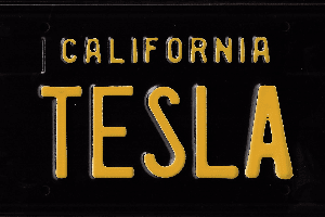 A black and yellow license plate with the words california tesla written in it.