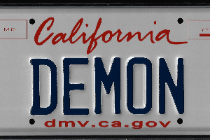A california license plate with the word " demon " on it.
